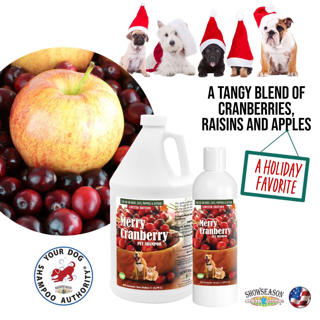 Merry Cranberry Pet Shampoo in 16 ounce and 1 gallon bottle placed over a white background. There are images of dogs in Santa hats in the top right corner. There is also an apple sitting on top of some cranberries on the middle left side. 