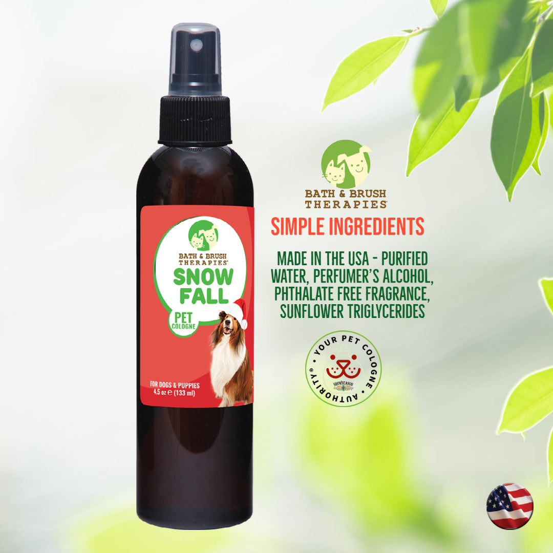 Bath and Brush Therapies Snow Fall Pet Cologne in a 4.5 ounce bottle that is positioned on a white background with leaves. The "Your Pet Cologne Authority" badge and american flag badge are included. Text reads "Bath and Brush Therapies, Simple Ingredients, Made in the USA - Purified water, perfumer's alcohol, phthalate free fragrance, sunflower triglycerides."
