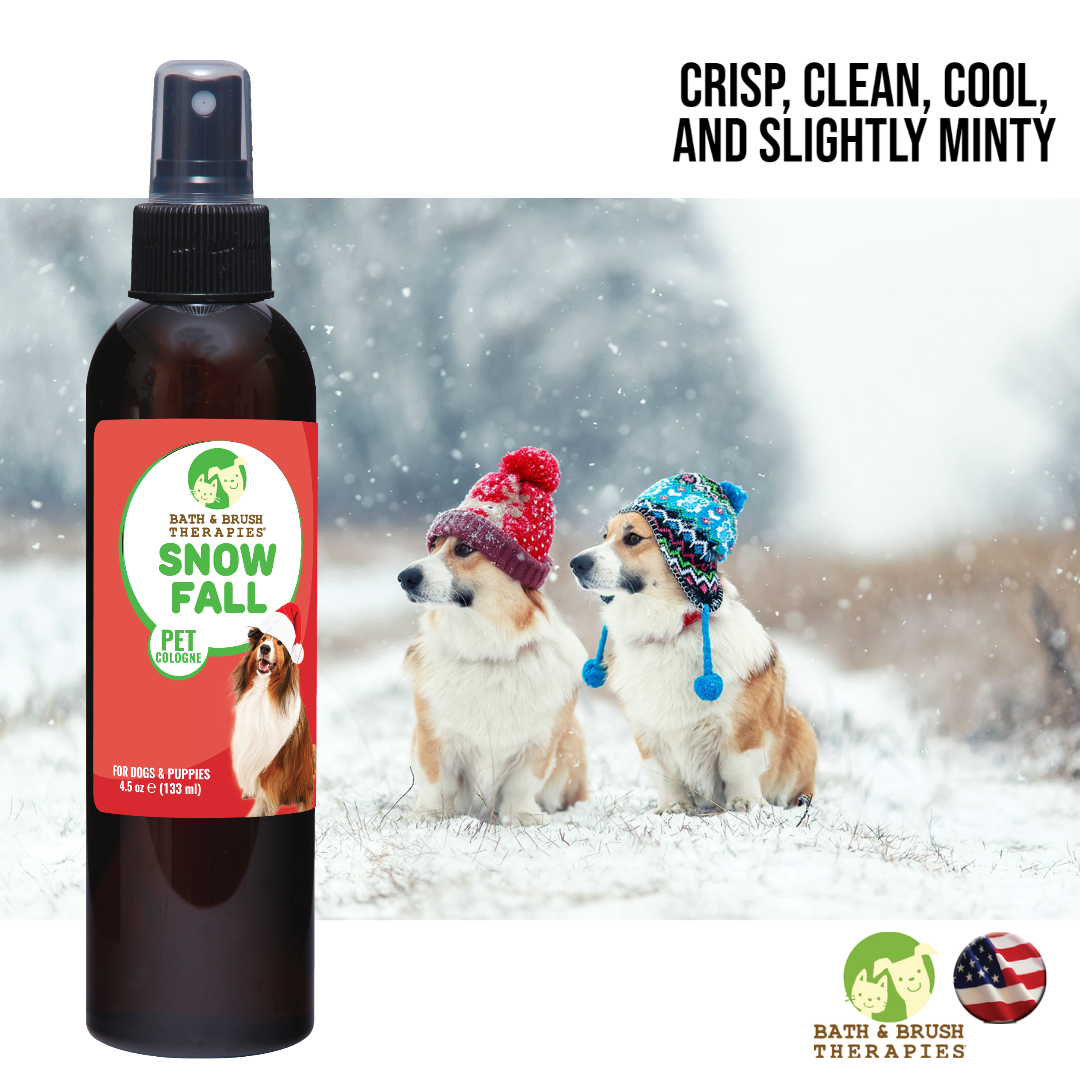 Bath and Brush Therapies Snow Fall Pet Cologne 4.5 ounce bottle on a background that shows two dogs with stocking caps on sitting in a field with snow. The text reads, "Crisp, clean, cool, and slightly minty".
