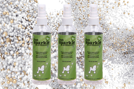 Just Sparkle Pet Finishing Spray in three 8.5 ounce bottles over a glitter background. 